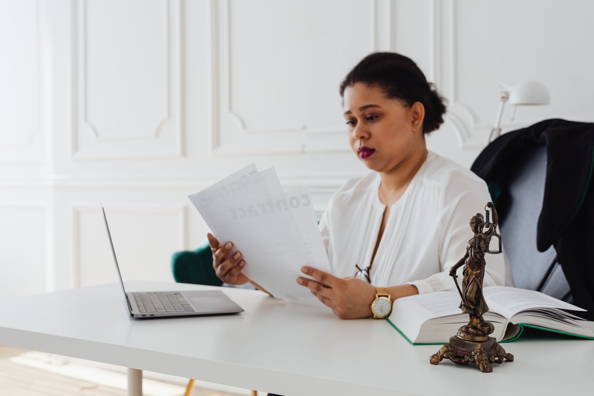 Attorney reviewing documents at her desk