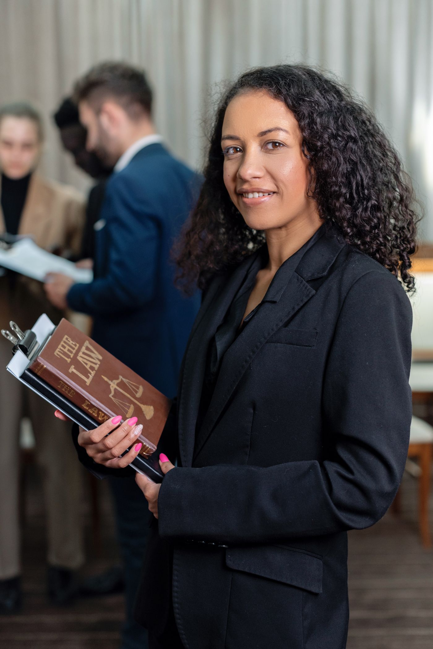 Attorney holding a law book in a busy office